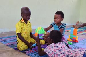 children playing with plastic blocks in a child-friendly space in cote d'ivoire