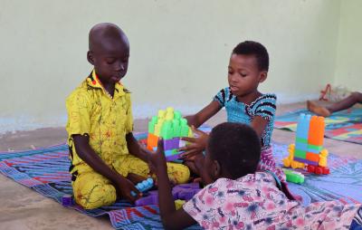 children playing with plastic blocks in a child-friendly space in cote d'ivoire