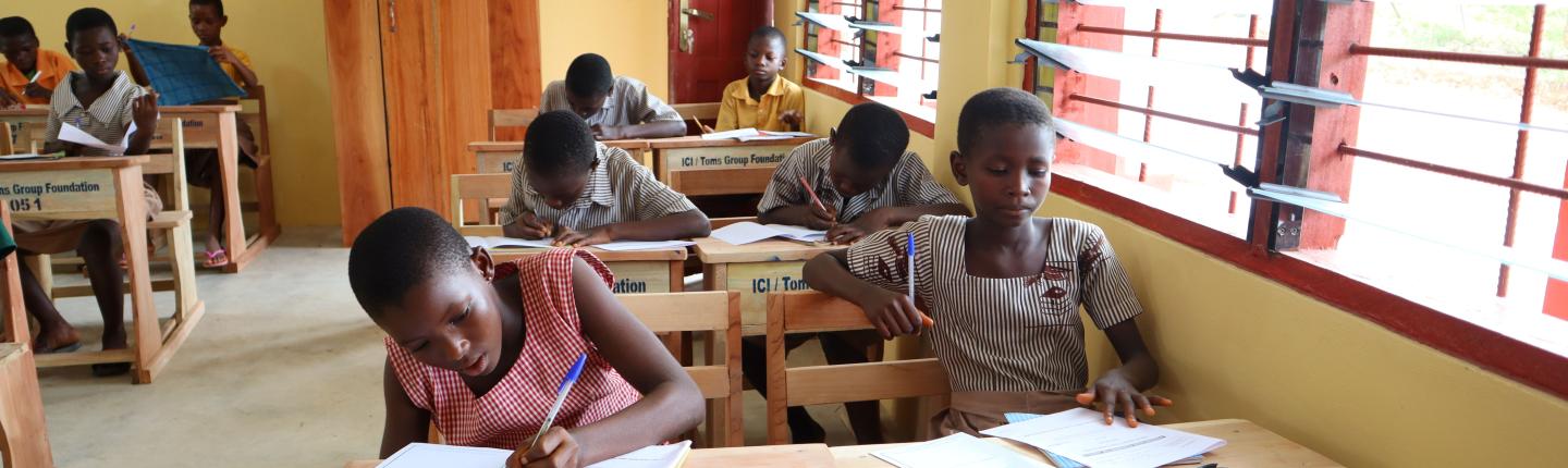 children sitting at desks in school classroom